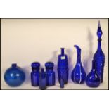 A collection of 20th Century blue glass items to include bulbous vase having a glazed effect, tall