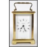A mid-20th century French 8 Day carriage clock by Bayard. The brass case with glass viewing panels