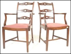 A pair of 20th Century mahogany rail back elbow chairs, the rail backs with pierced carved detail to