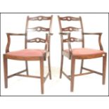 A pair of 20th Century mahogany rail back elbow chairs, the rail backs with pierced carved detail to