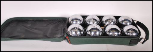 A set of 20th Century Boules to include six silver balls and two jaques within a green canvas