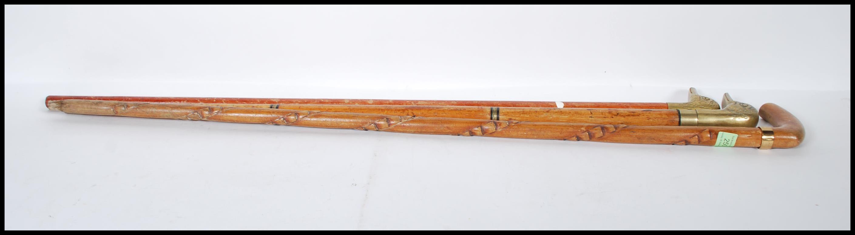 A group of three vintage 20th Century walking stick canes, two having brass duck head handles, the - Image 2 of 5