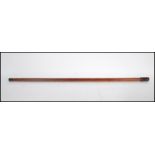 A 20th Century concealed pipe walking stick cane having a dark wood knop which removes to form a