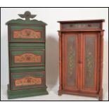 Two 20th Century Swiss style painted cabinet cupboards, the first a series of three panel drawers