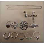 A collection of silver jewellery to include seven rings of differing designs including a red stone