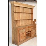 A 19th Century Victorian large stripped pine Welsh dresser three drawers over cupboards, plate