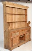 A 19th Century Victorian large stripped pine Welsh dresser three drawers over cupboards, plate