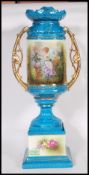A early 20th Century Continental twin handled ceramic urn vase having a blue turquoise painted