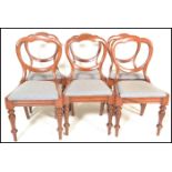 A set of six 19th Century Victorian mahogany balloon back dining chairs, upholstered stuffed seats