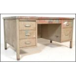 A 20th century metal industrial engineers twin pedestal kneehole desk with a rubber insert / skiver,