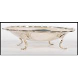 A silver hallmarked pin dish, scalloped rim raised on four pad feet, Sheffield assay mark, dating to