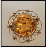 A Victorian hallmarked 9ct yellow gold brooch set with a large faceted cut citrine to the open