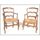 A pair of 20th Century French fruit wood Louis XV style elbow / fauteuil armchairs, serpentine