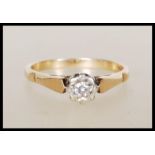 A hallmarked 9ct gold solitaire ring illusion set with a round cut white stone. Hallmarked London.