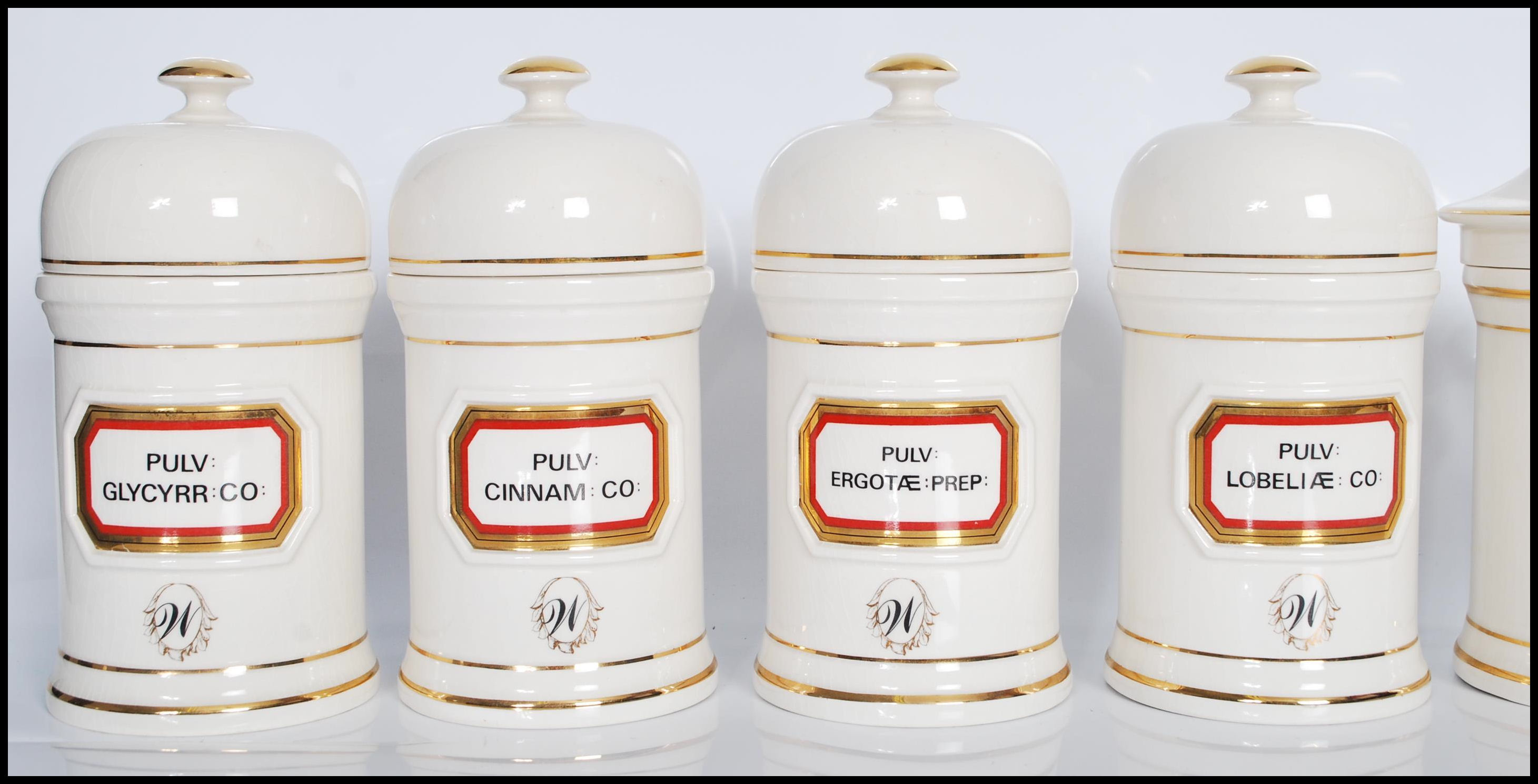 A group of twelve 20th Century Chalsyn Ltd ceramic apothecary jars and covers all having white - Image 5 of 10