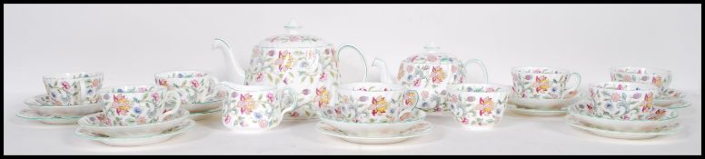 A vintage Minton tea service in the Harron Hall pattern decorated with pink and green floral sprays,