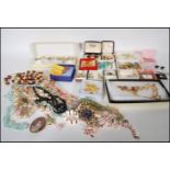 A collection of vintage 20th Century costume jewellery to include beaded necklaces, brooches, a