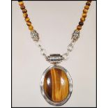 A stamped 925 silver and tiger's eye necklace pendant having magnetic clasp on tigers eye beaded