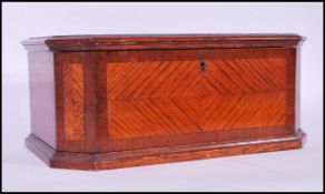 A 19th Century oak sewing work box of hexagonal form having decorative quarter veneer mahogany