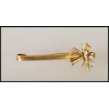 A stamped 9ct gold J Aitkin & Son hunting interest bar brooch having an applied finial with a fox