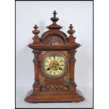 A late 19th Century walnut cased mantel clock, eight day movement by Junghans striking on coiled