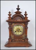 A late 19th Century walnut cased mantel clock, eight day movement by Junghans striking on coiled