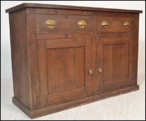 A 19th Century Victorian pine dresser base, flared top over drawers and cupboards fitted with cup