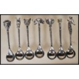 A selection of pewter tea spoons each having African animal head finials and twisted stems. Makers