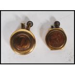 Two 20th Century military WW2 trench art brass lighters of round form one inset with a British coin,