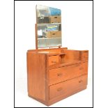A mid 20th Century oak dressing chest in the manner of Ernst Gomme for G-Plan, central mirror