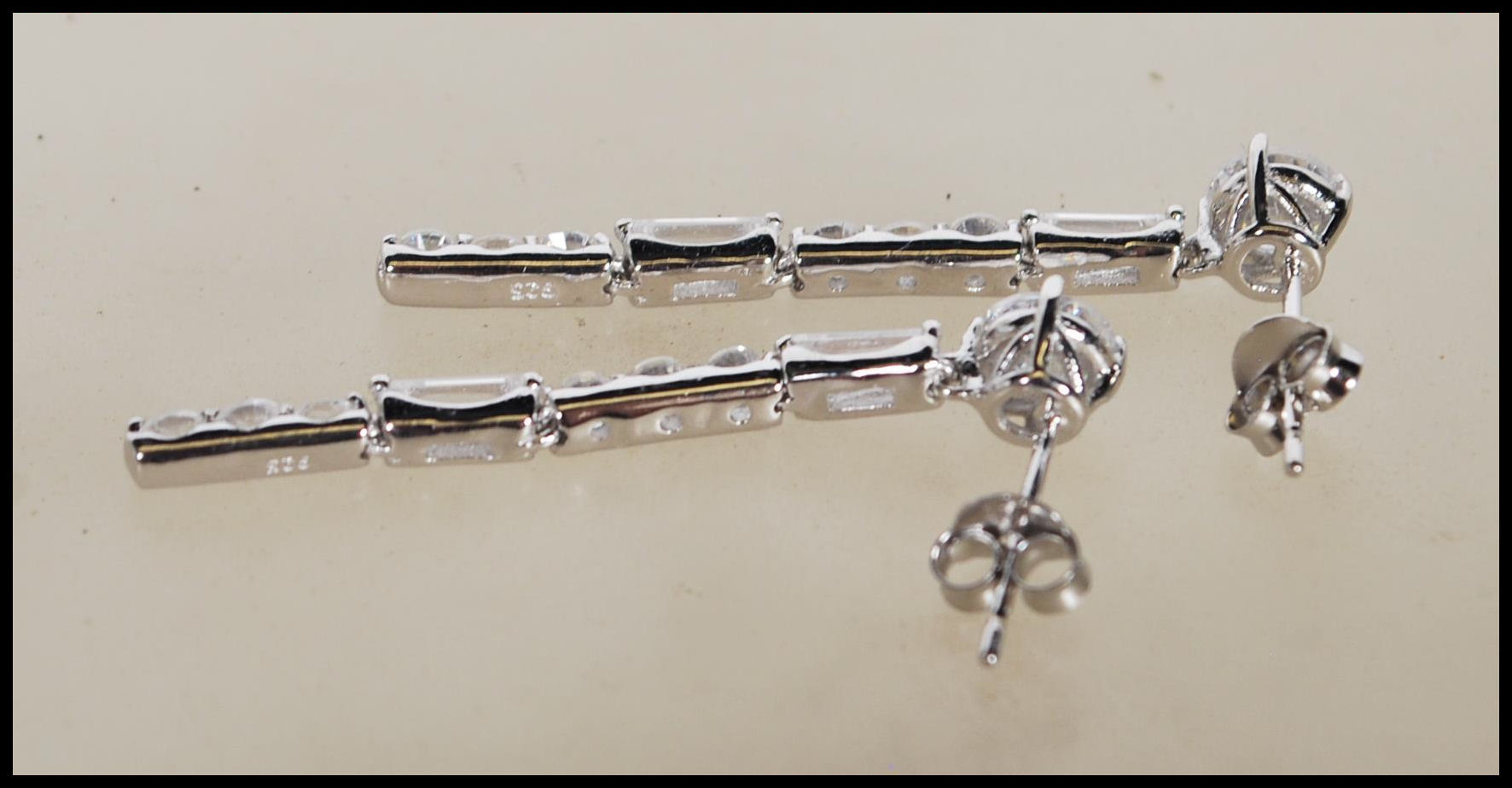 A pair of stamped 925 silver drop earrings set with Cz's. Stamped 925 to verso. Measure 1.5 inches - Image 3 of 4