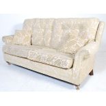 A pair of matching contemporary three seat scroll arm button back sofa settees in the manner of