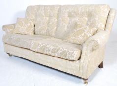 A pair of matching contemporary three seat scroll arm button back sofa settees in the manner of