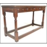 An early 20th Century Jacobean peg jointed oak lowboy hall table / side table having a flared top