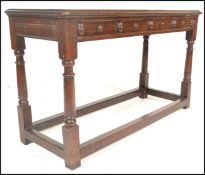 An early 20th Century Jacobean peg jointed oak lowboy hall table / side table having a flared top