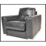 A retro 20th Century black leather Danish style easy chair/ lounge chair /  armchair, the chair of