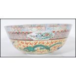 An early / mid 20th Century Chinese centrepiece bowl having a yellow ground hand painted with four