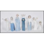 A collection of Nao and Lladro ceramic figurines to include a Lladro nun, a Lladro praying cherub,