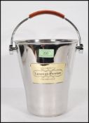 A vintage Laurent Perrier brushed steel champagne ice bucket having a leather swing handle and