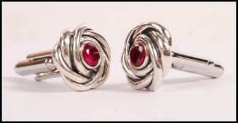 A pair of sterling silver knot design cufflinks se