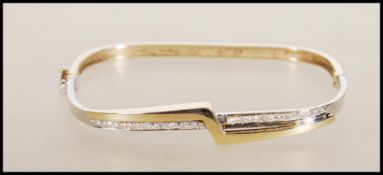 A hallmarked 9ct gold bangle of square form having