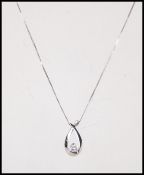 A 10ct white gold and diamond necklace and pendant