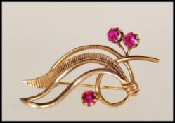 A 9ct gold and red stone hallmarked brooch of Art