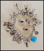 A silver hallmarked charm bracelet having silver h