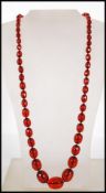 A cherry bakelite necklace having fiftyfive gradua