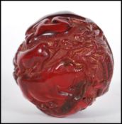 A 20th Century Chinese deep red resin sphere decor