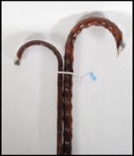 Two early 20th Century walking stick canes having