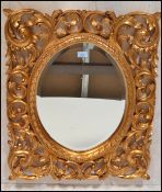 A large Florentine  style gilt wall mirror, the ce