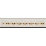 A 14ct gold figural bracelet. The bracelet having