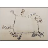 A silver charm bracelet having eleven charms inclu